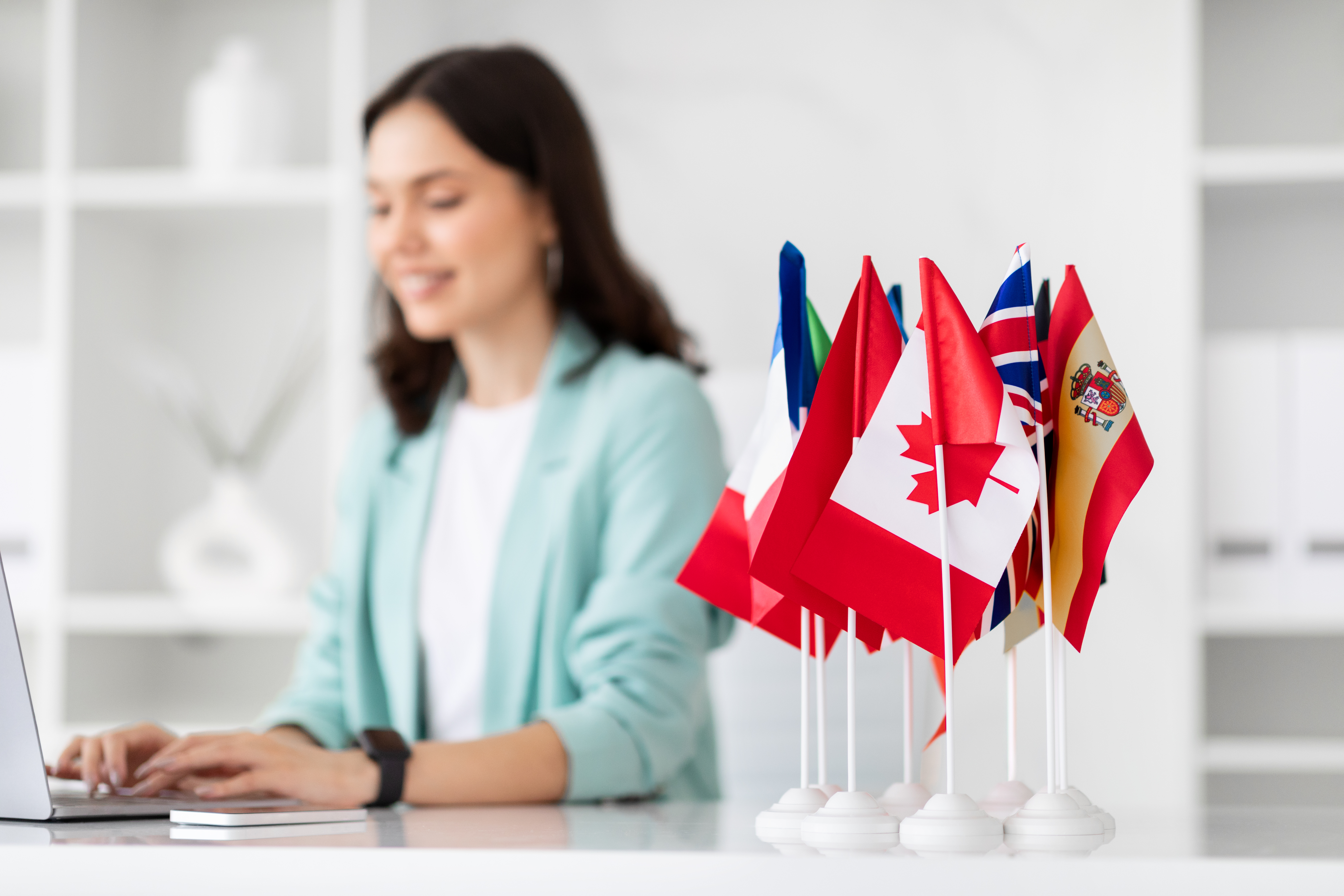 Happy young European woman manager at table